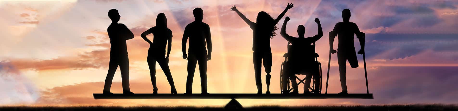 Silhouettes of diverse individuals, including a person in a wheelchair and a person on crutches, balance on a seesaw against a sunset background symbolizing equality—much like an employment lawyer in Los Angeles advocating for fairness.